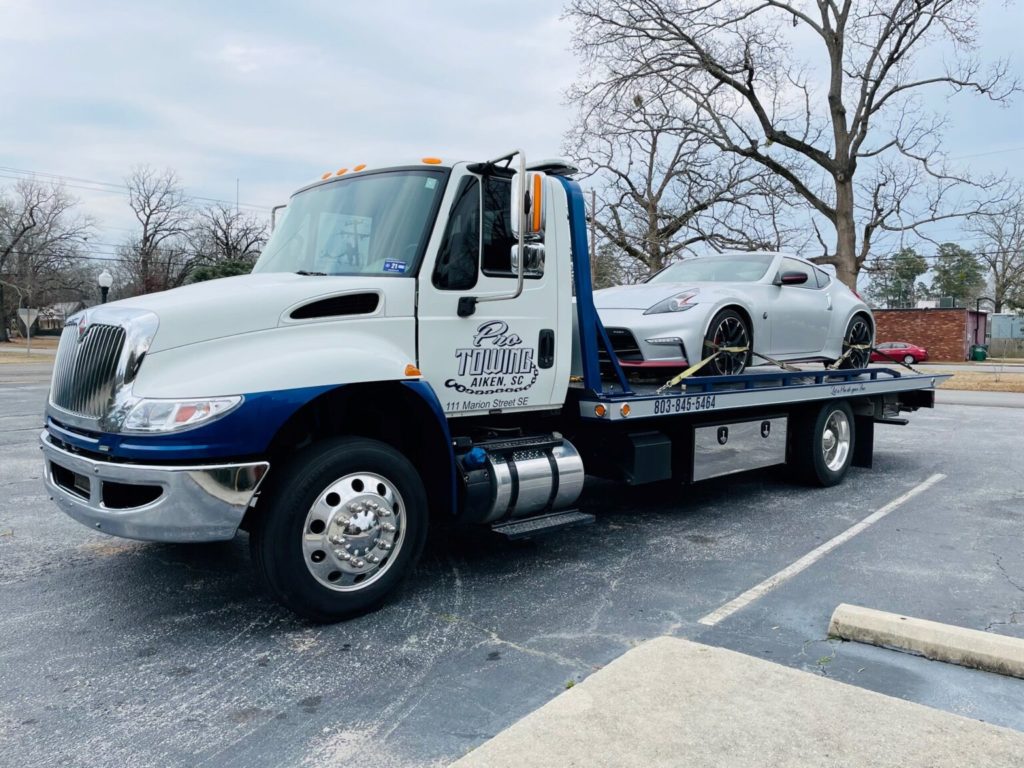 Pro Tow hauling a white luxury vehicle